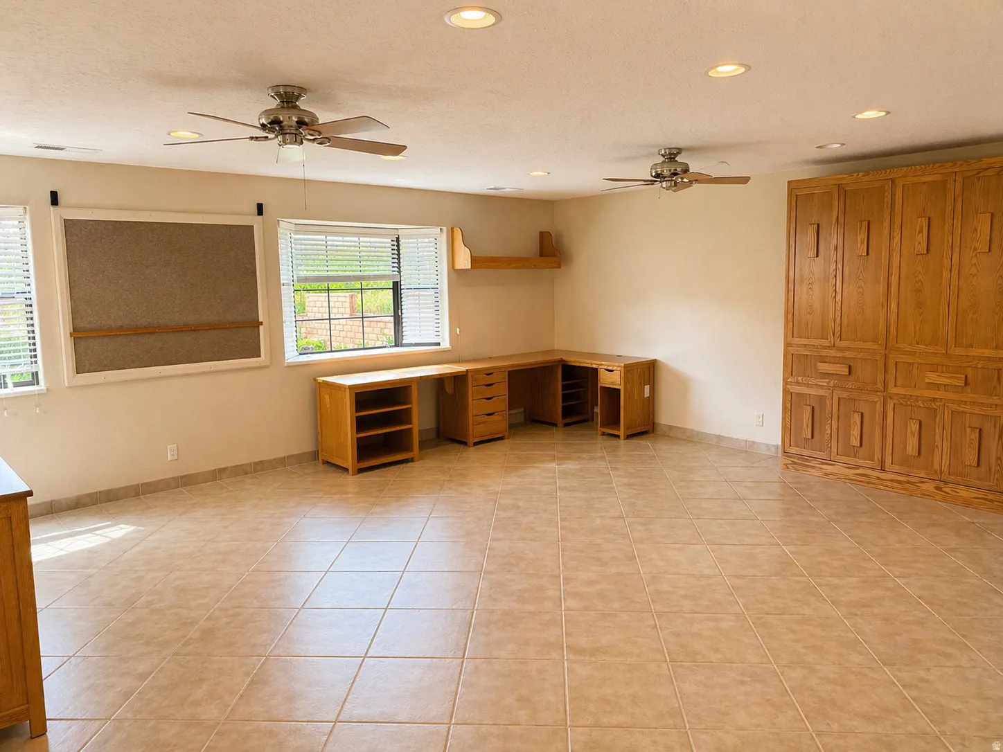 Unfurnished office with ceiling fan, recessed lighting, light tile patterned floors, and built in desk