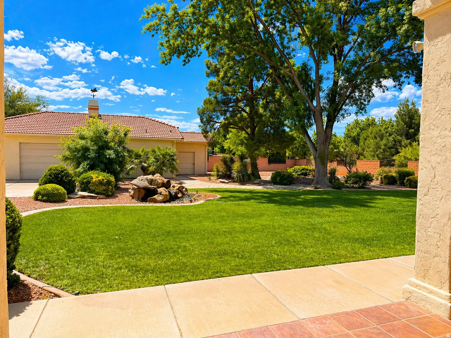 View of grassy yard with a garage
