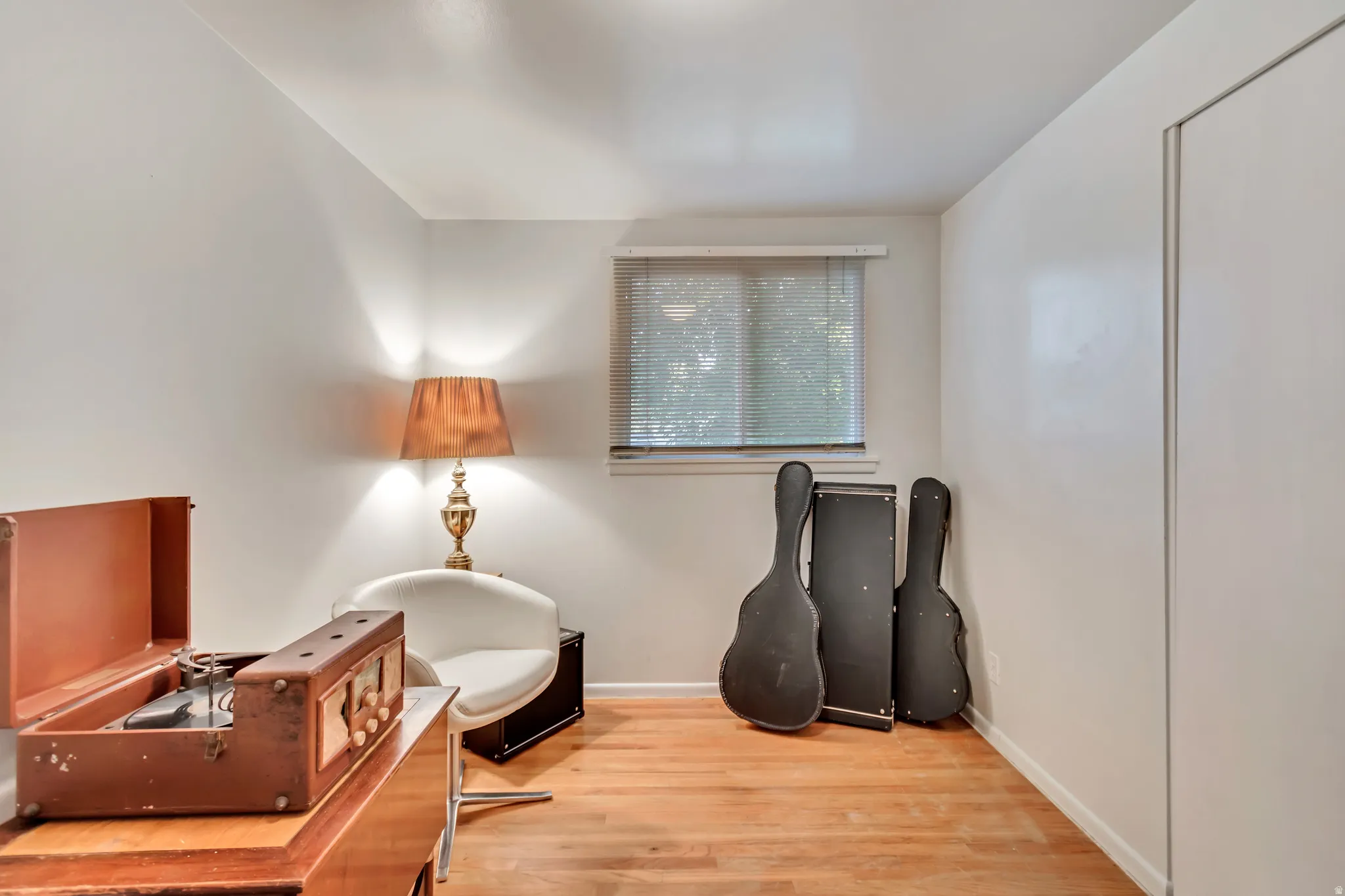 Second guest bedroom upstairs, currently used as a music room.  Original hardwood floors.