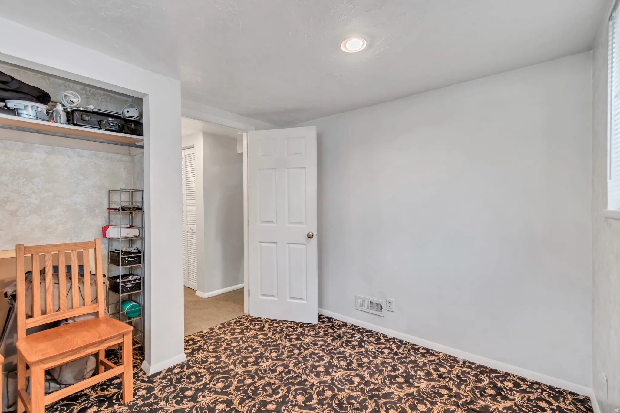 Another angle of the basement bedroom facing the interior door.