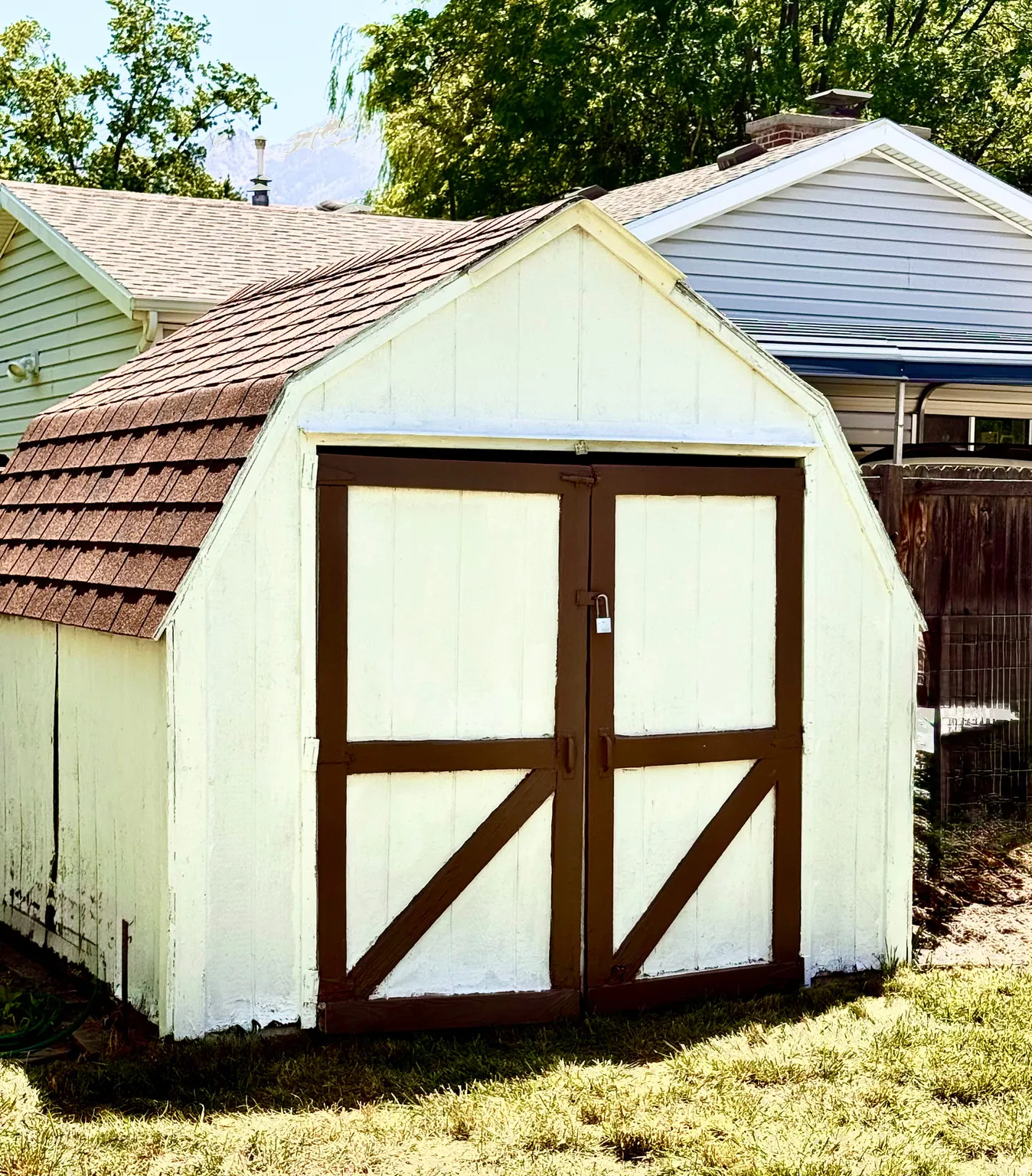 Gable shed with an asphalt shingle roof and double barn doors