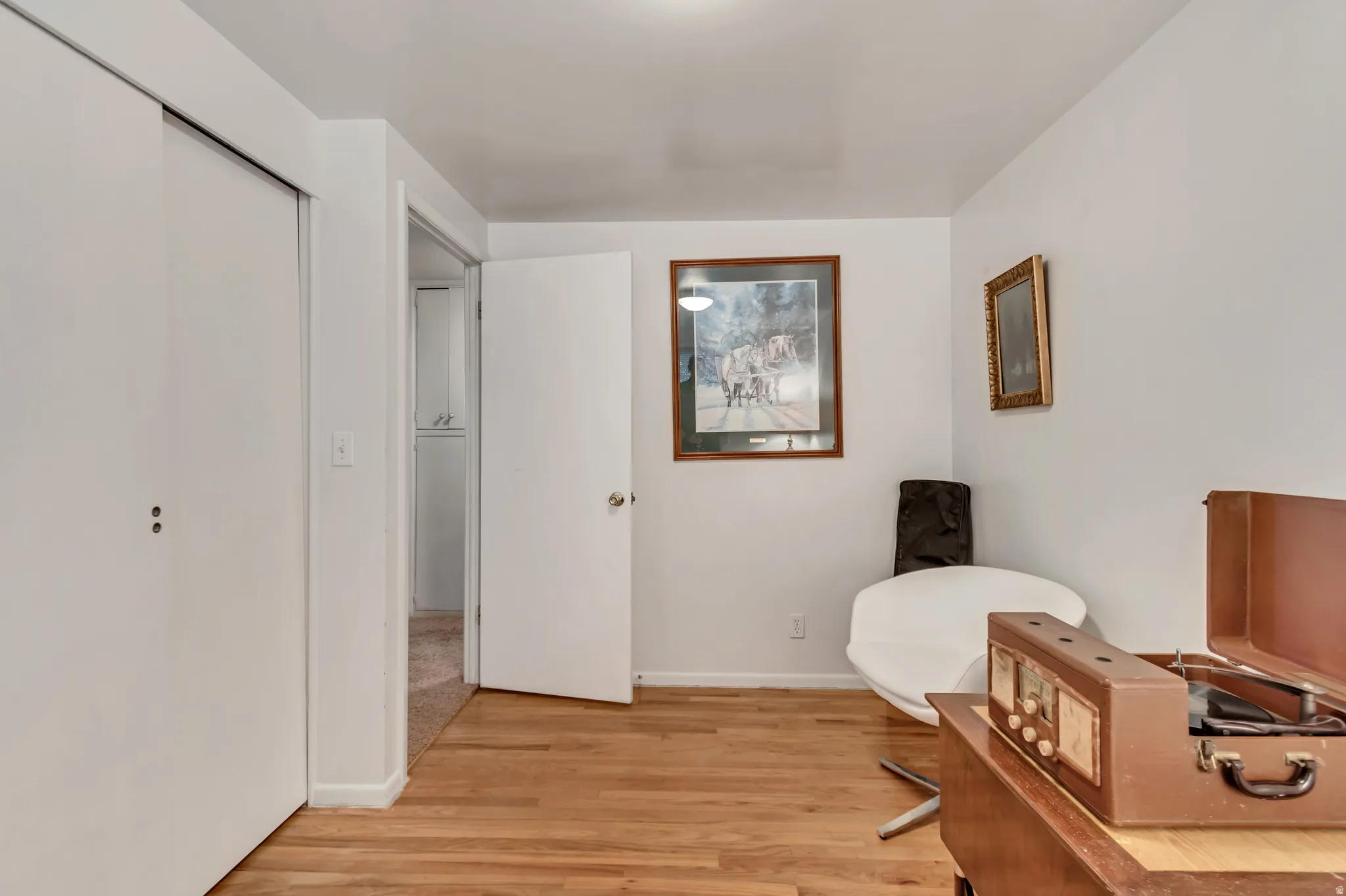 First guest bedroom upstairs, currently used as a home office. Original hardwood floors.