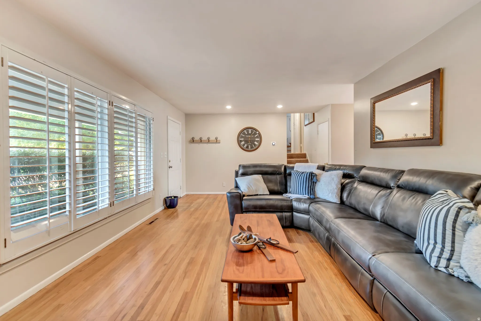 Excellent angle view of the family room that highlights the original hardwood.