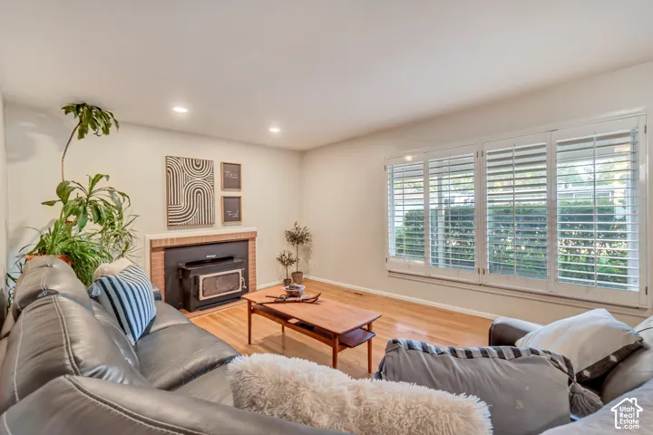 Family room featuring original hardwood floors, recessed lighting and a cozy fireplace.