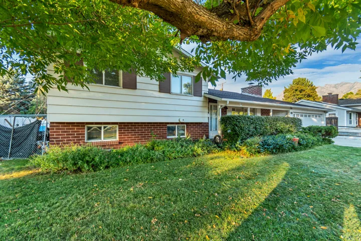Split-level home featuring brick siding.