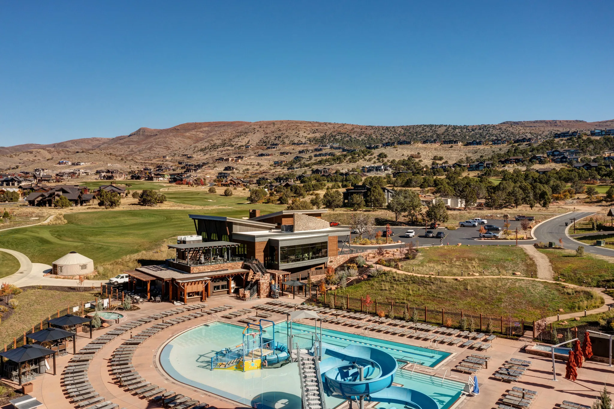 Drone / aerial view of mountains and a golf club