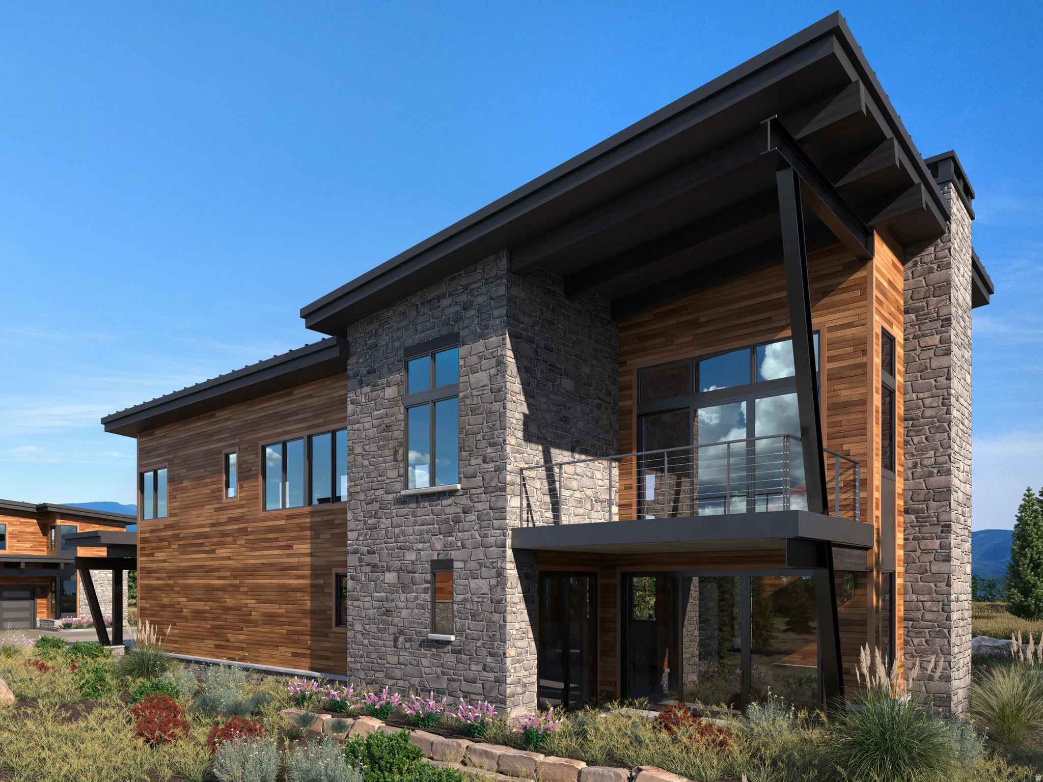 Back of property with a balcony and stone siding