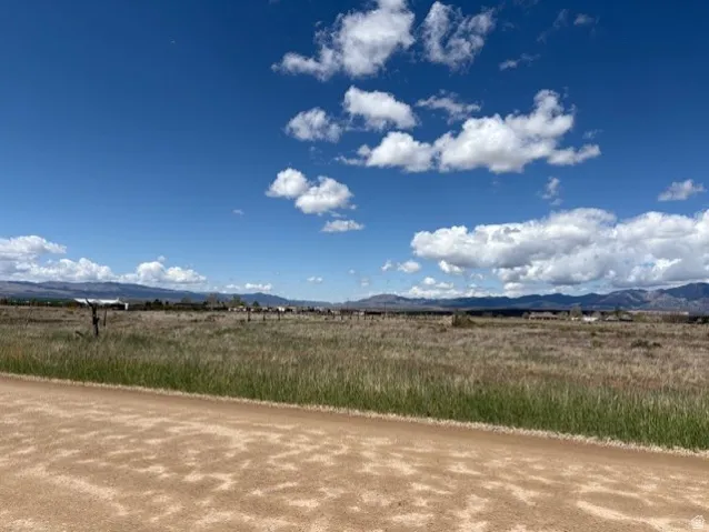 View of mountain backdrop with rural landscape