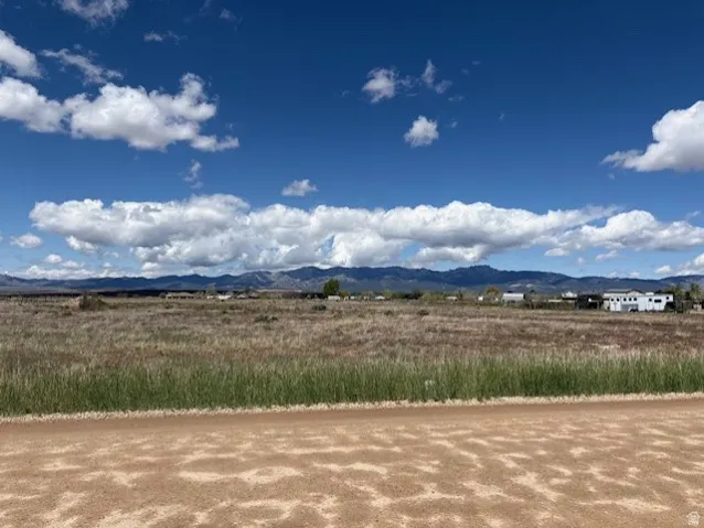 View of mountain backdrop with rural landscape