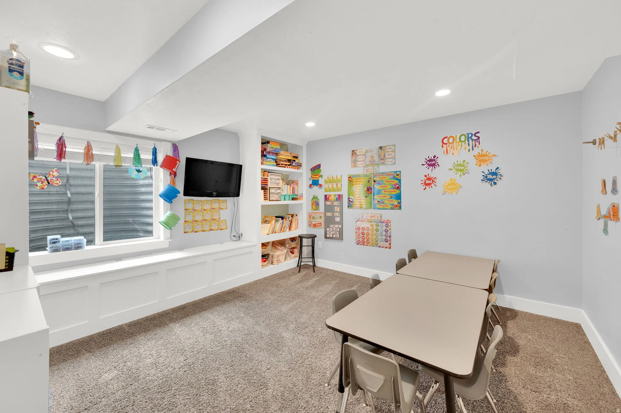 Rec room with carpet floors, built in shelves, and recessed lighting
