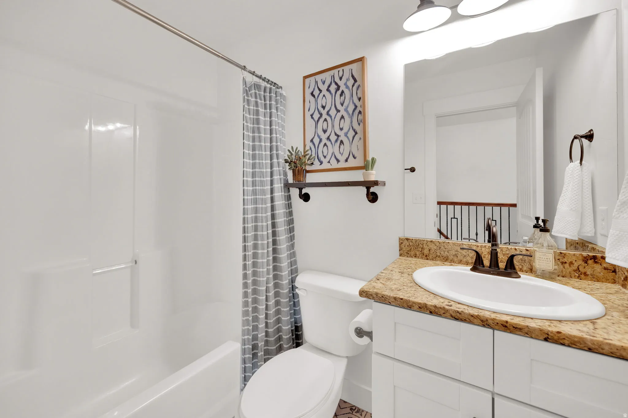 Bathroom featuring vanity and shower / tub combo