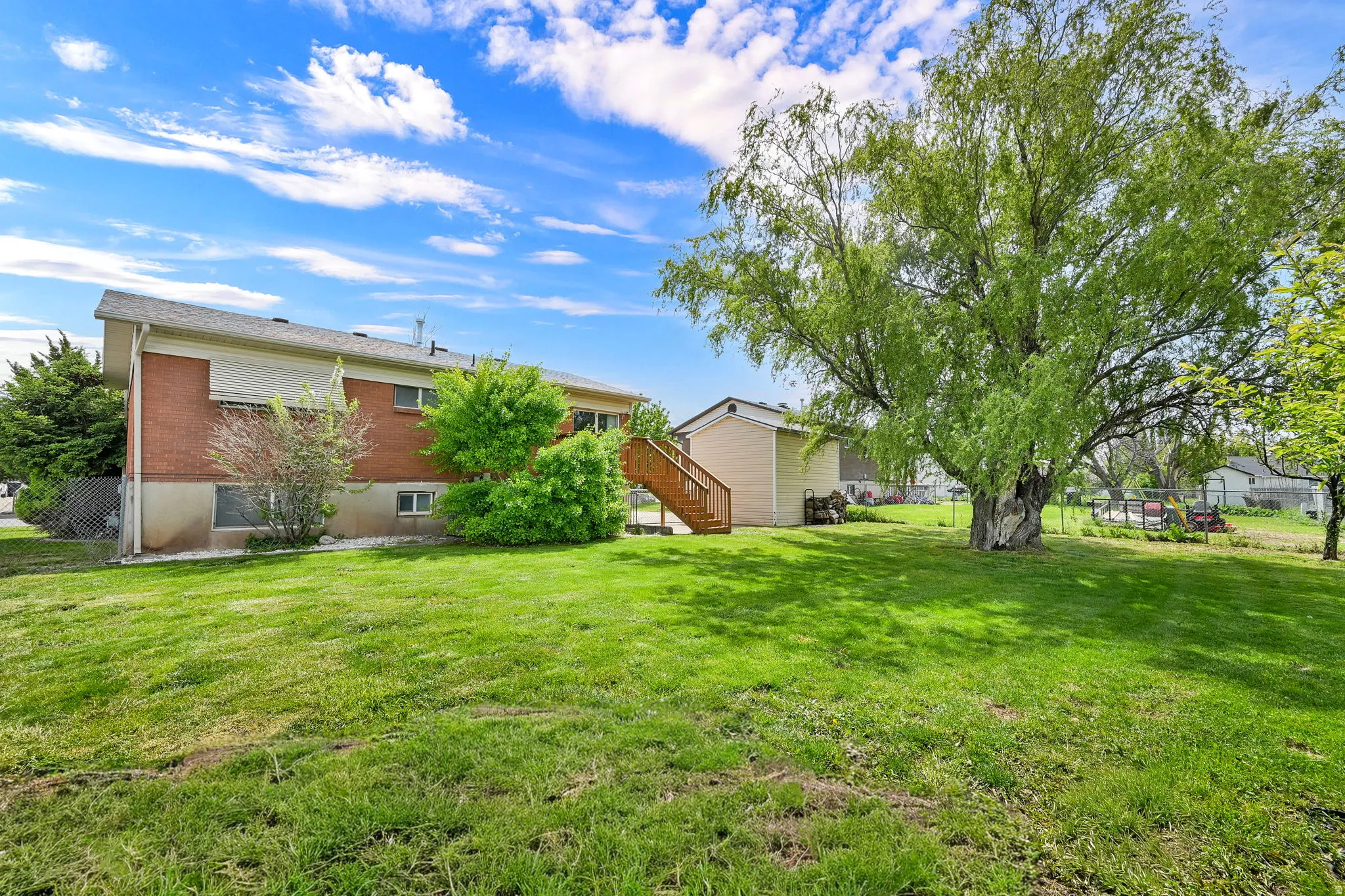 Fully fenced yard with fruit trees