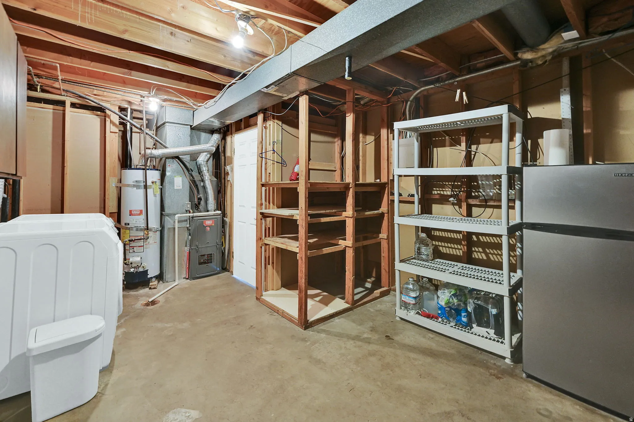 Laundry room includes washer and dryer and storage