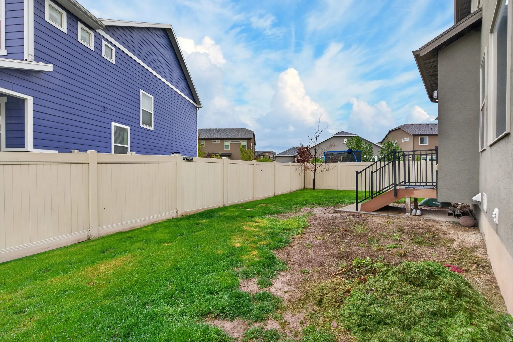 Fenced backyard featuring a residential view