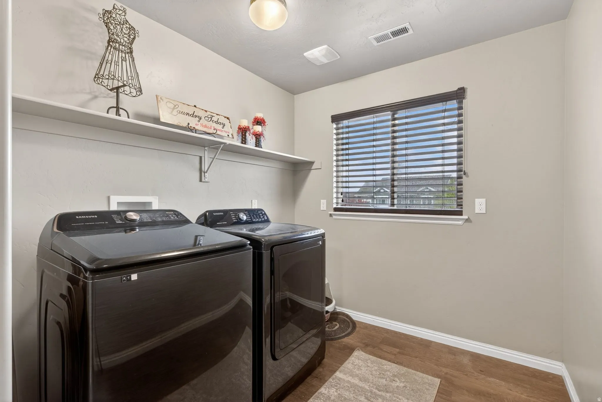 Laundry room featuring washing machine and clothes dryer and wood finished floors