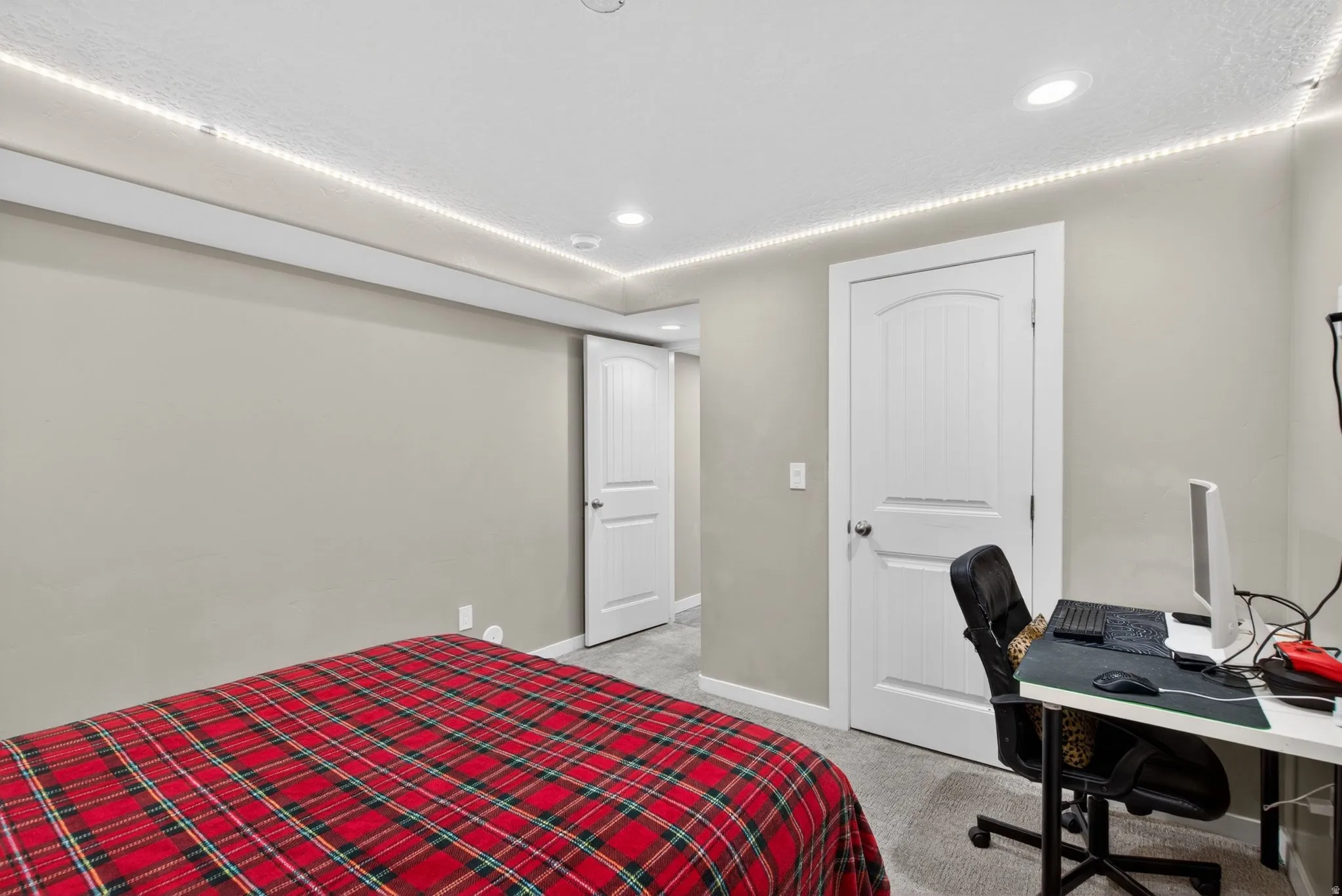 Bedroom featuring an office area, light colored carpet, and recessed lighting