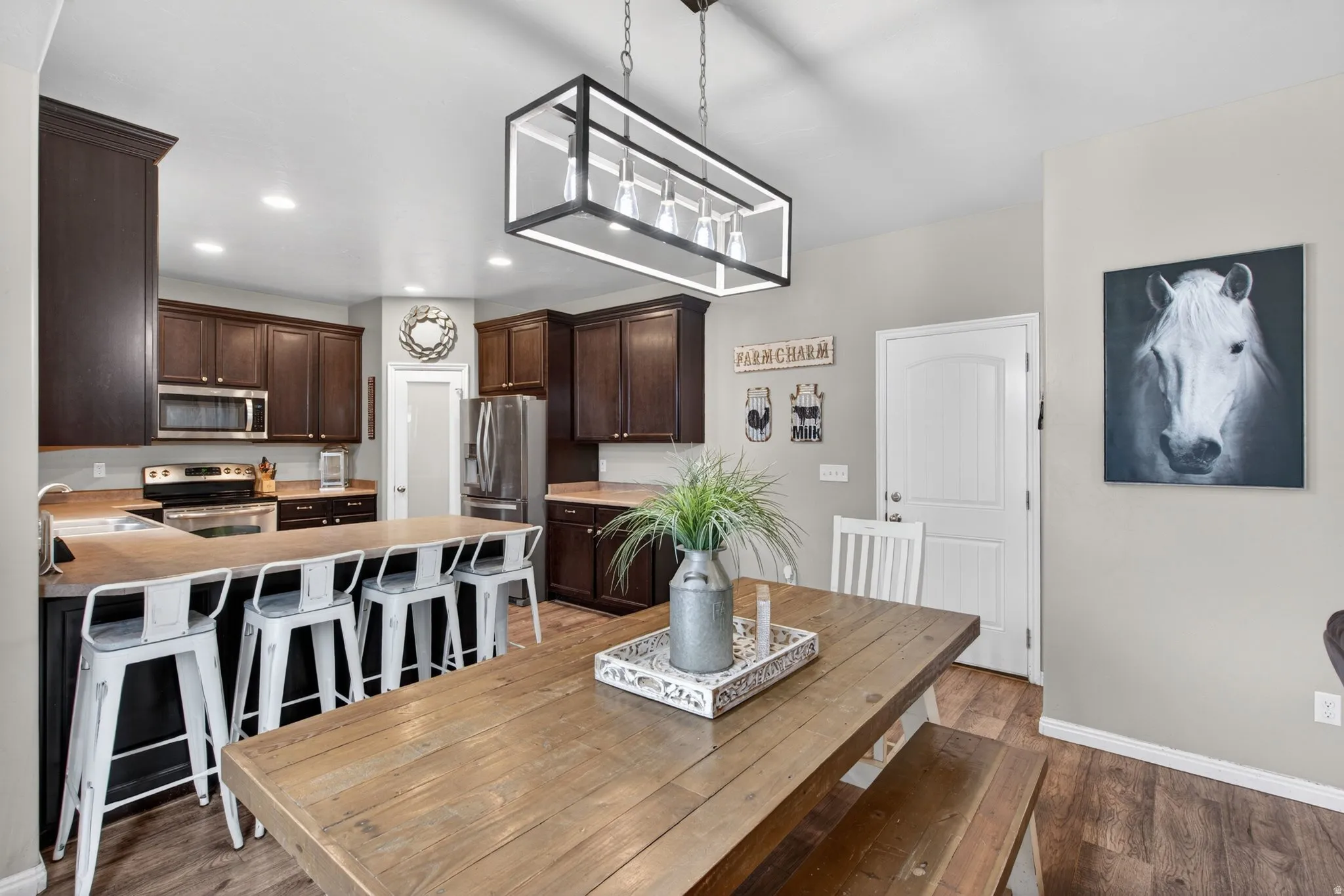 Dining space with light wood-type flooring and recessed lighting
