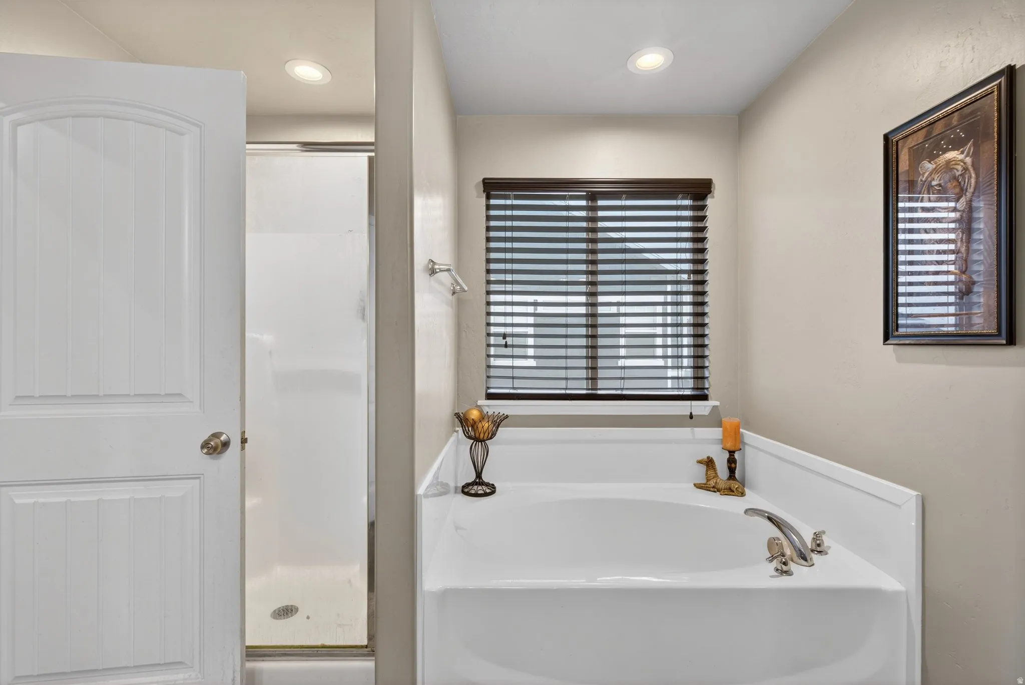 Full bath featuring a stall shower, a bath, and recessed lighting