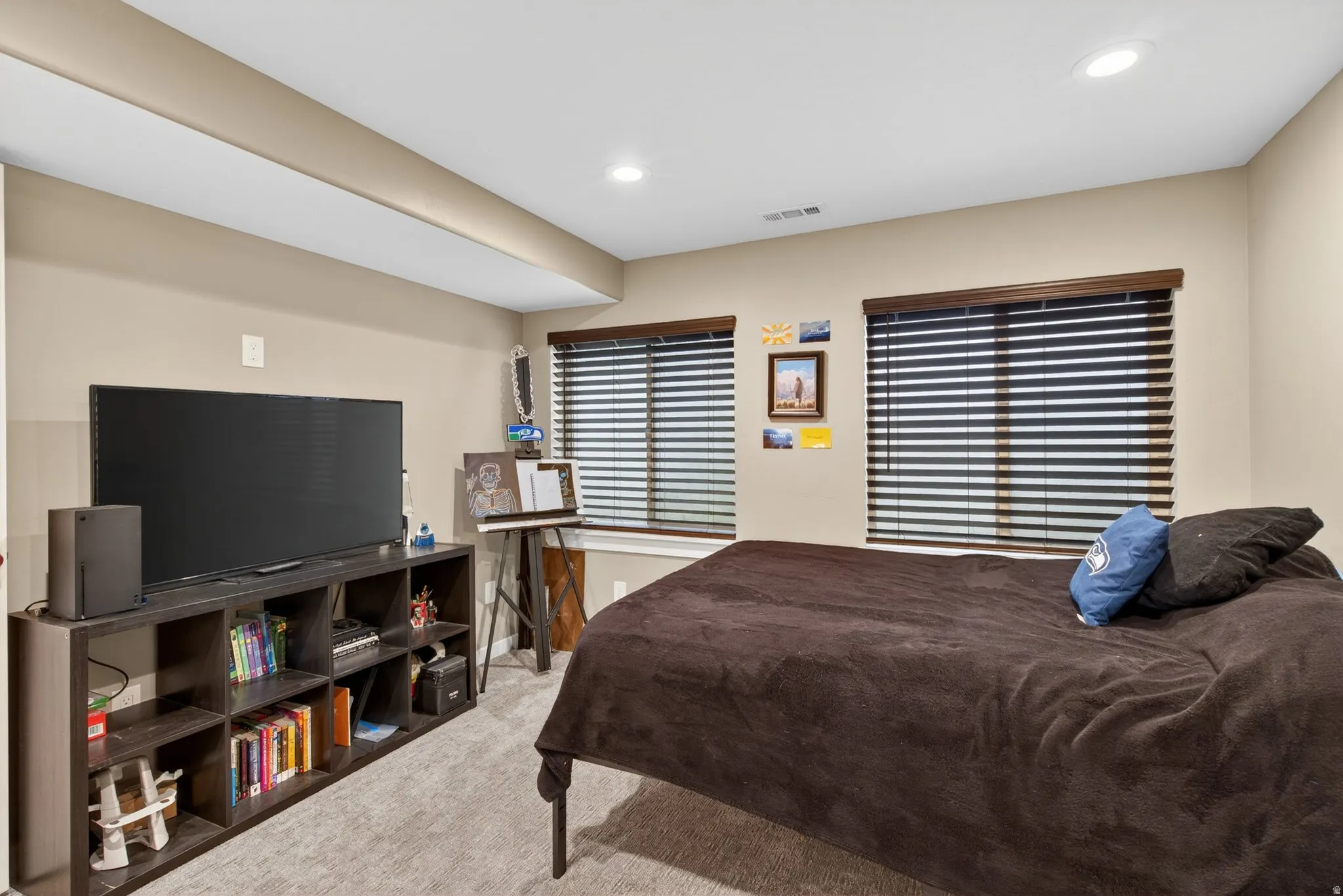 Carpeted bedroom with recessed lighting