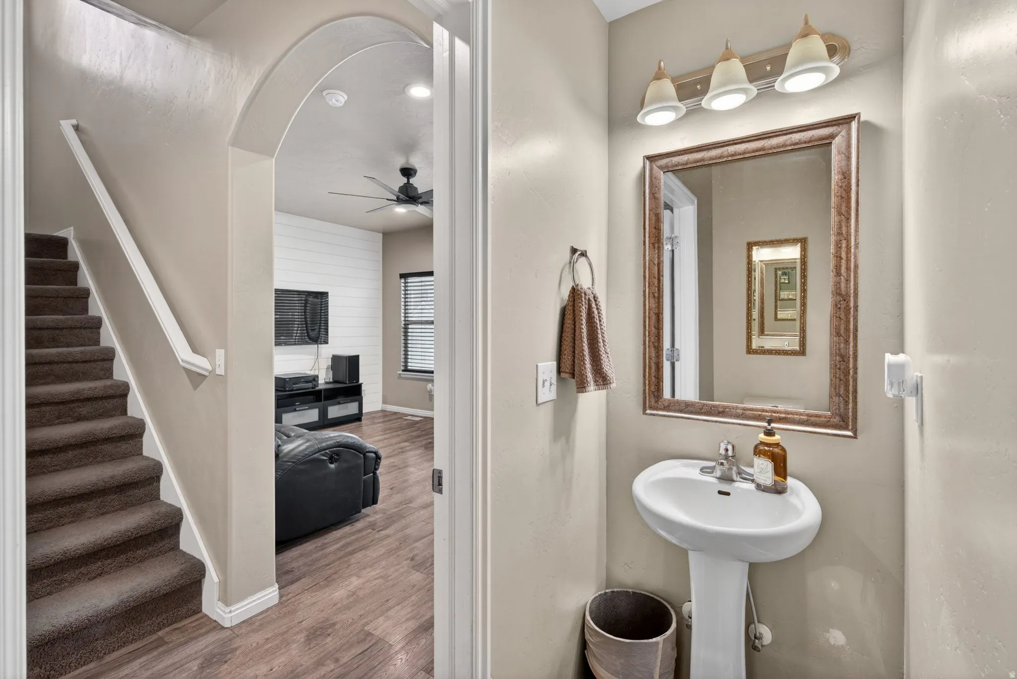 Bathroom featuring wood finished floors and a ceiling fan