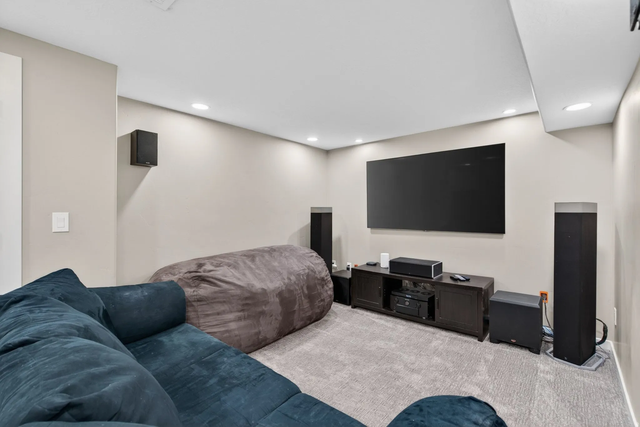 Bedroom with light colored carpet and recessed lighting