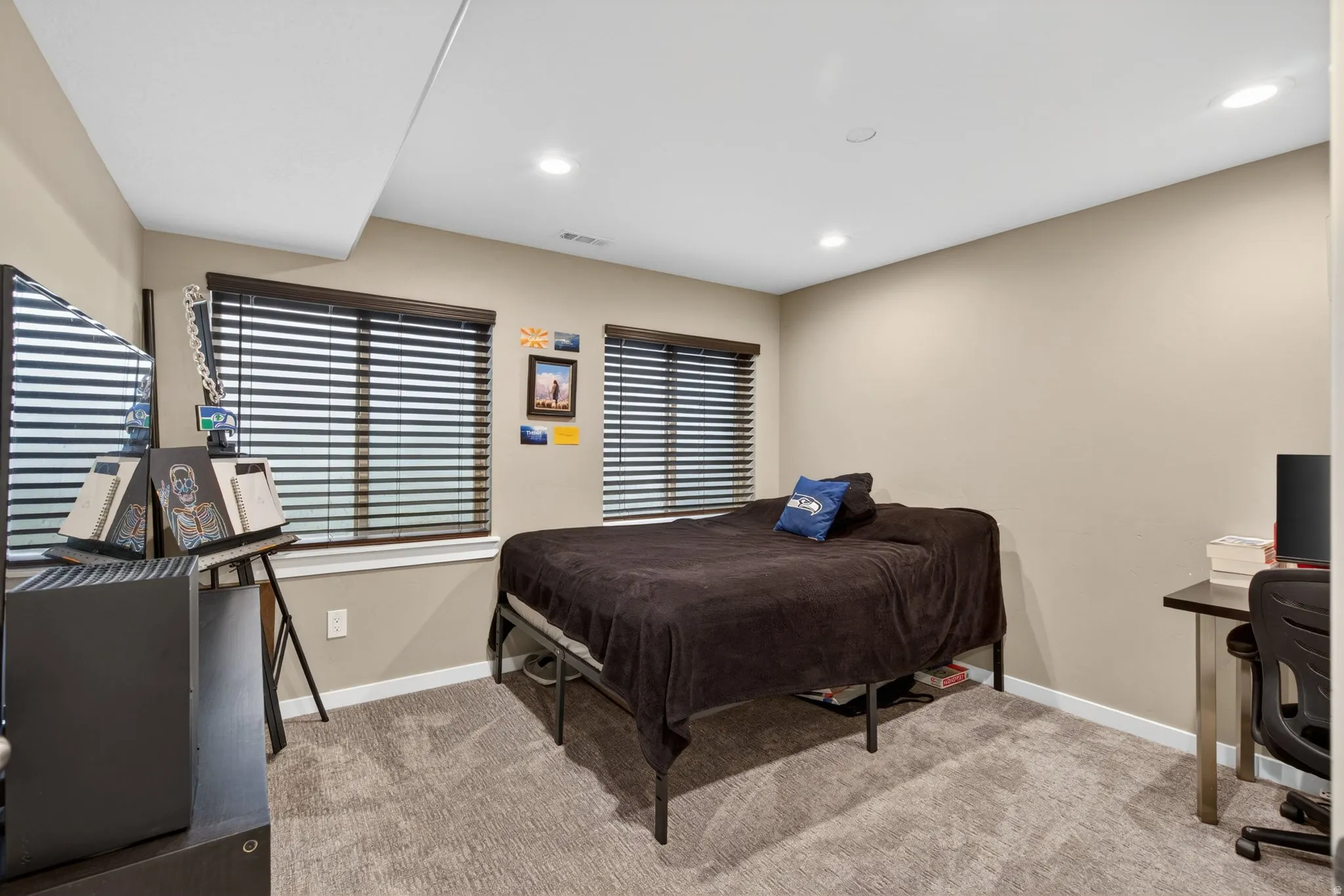 Bedroom featuring an office area, light colored carpet, and recessed lighting