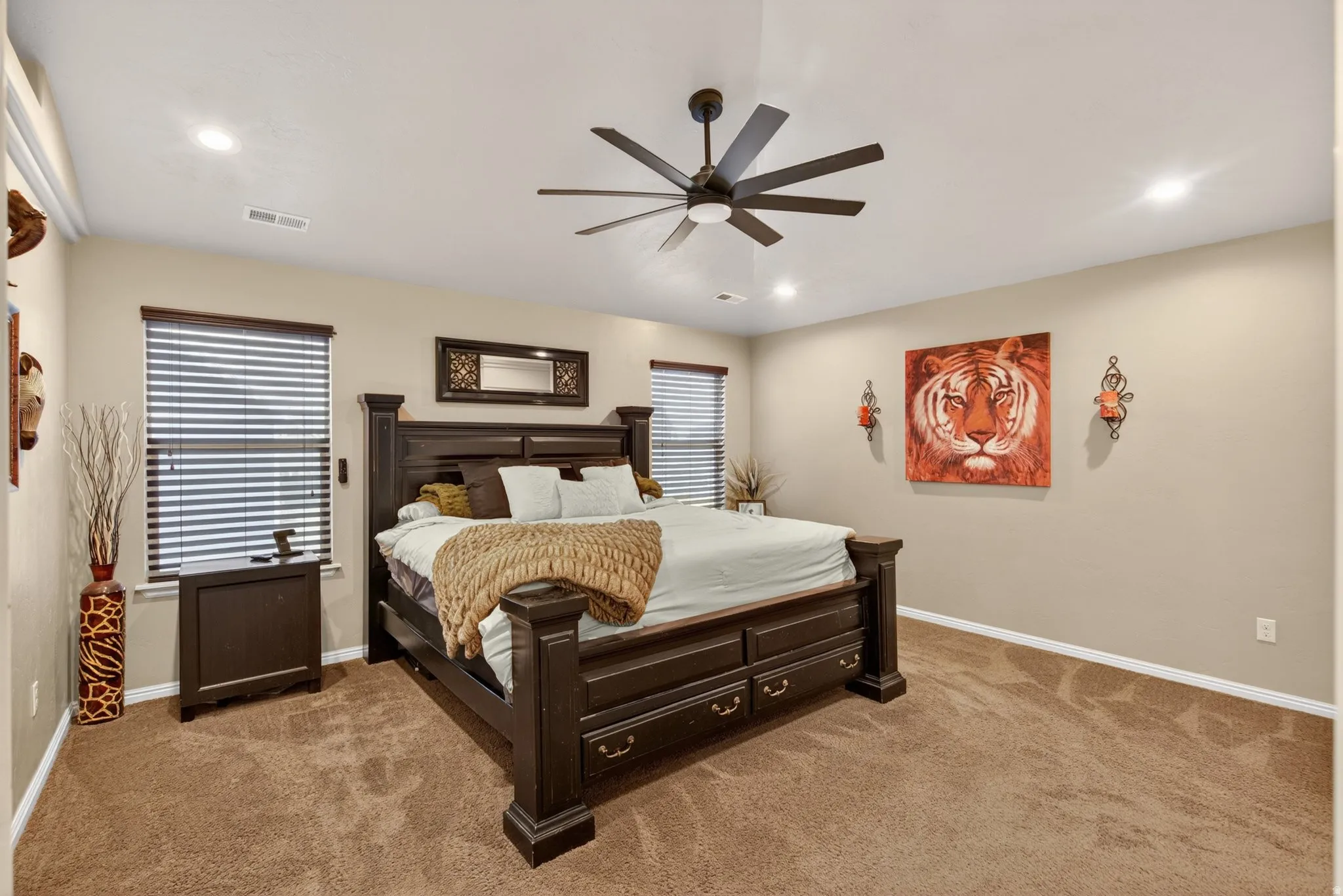 Bedroom with light carpet, ceiling fan, and recessed lighting