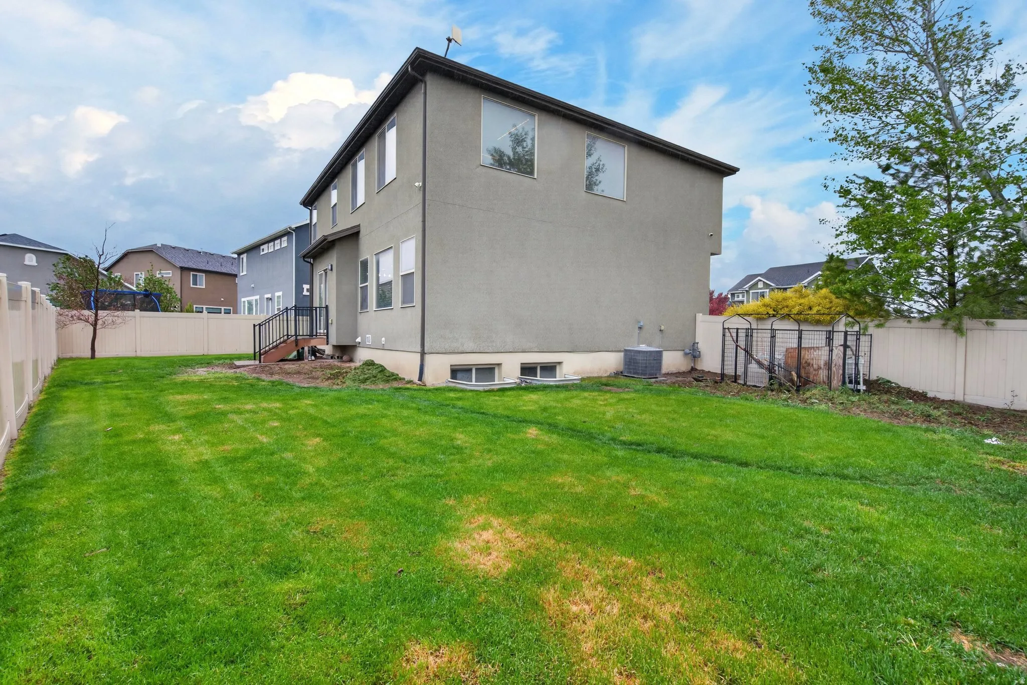 Back of property featuring a fenced backyard