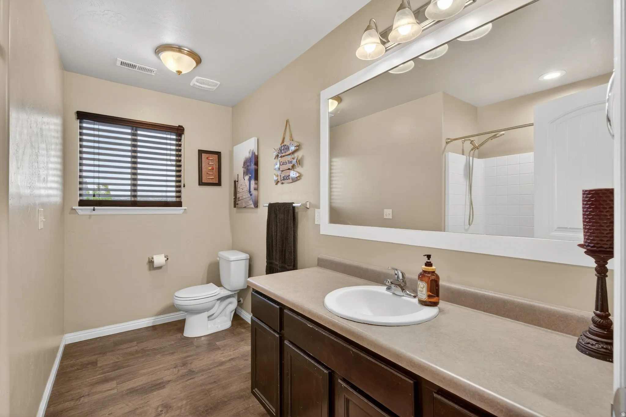 Full bathroom with vanity, a shower, and dark wood-style flooring