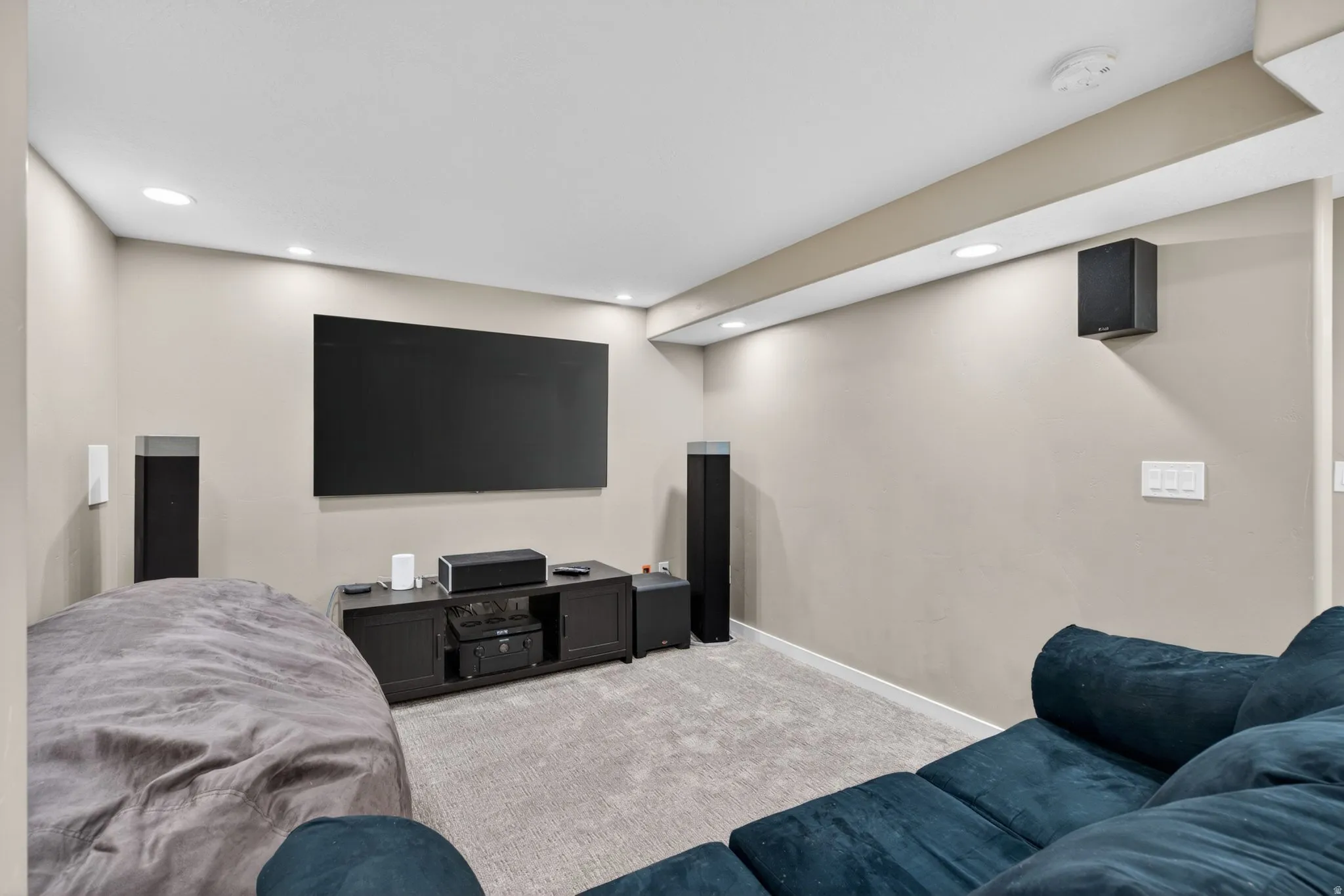 Cinema room with carpet and recessed lighting
