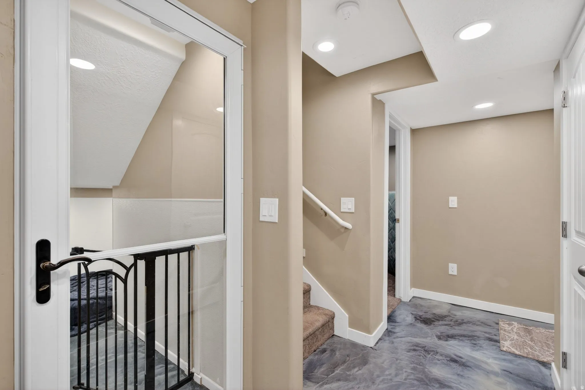 Stairway featuring recessed lighting and concrete flooring
