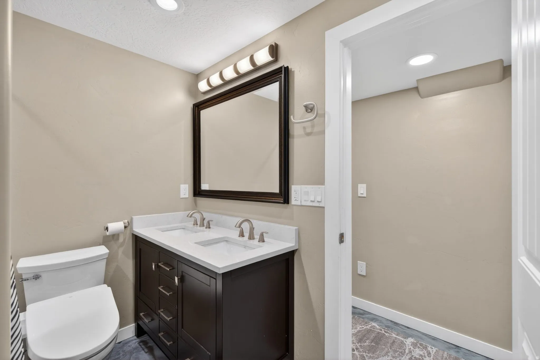 Bathroom with double vanity and recessed lighting