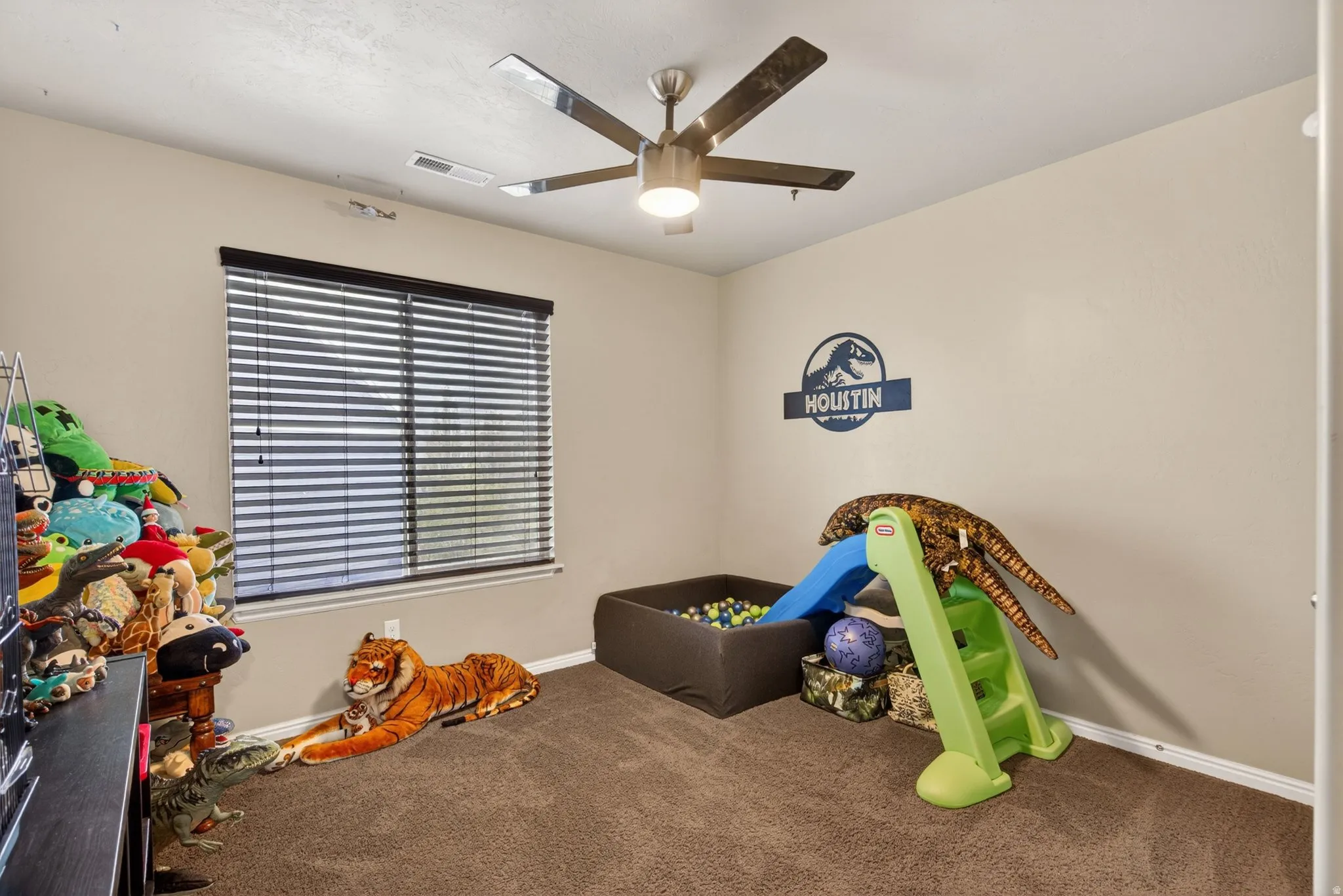 Rec room featuring carpet floors and a ceiling fan