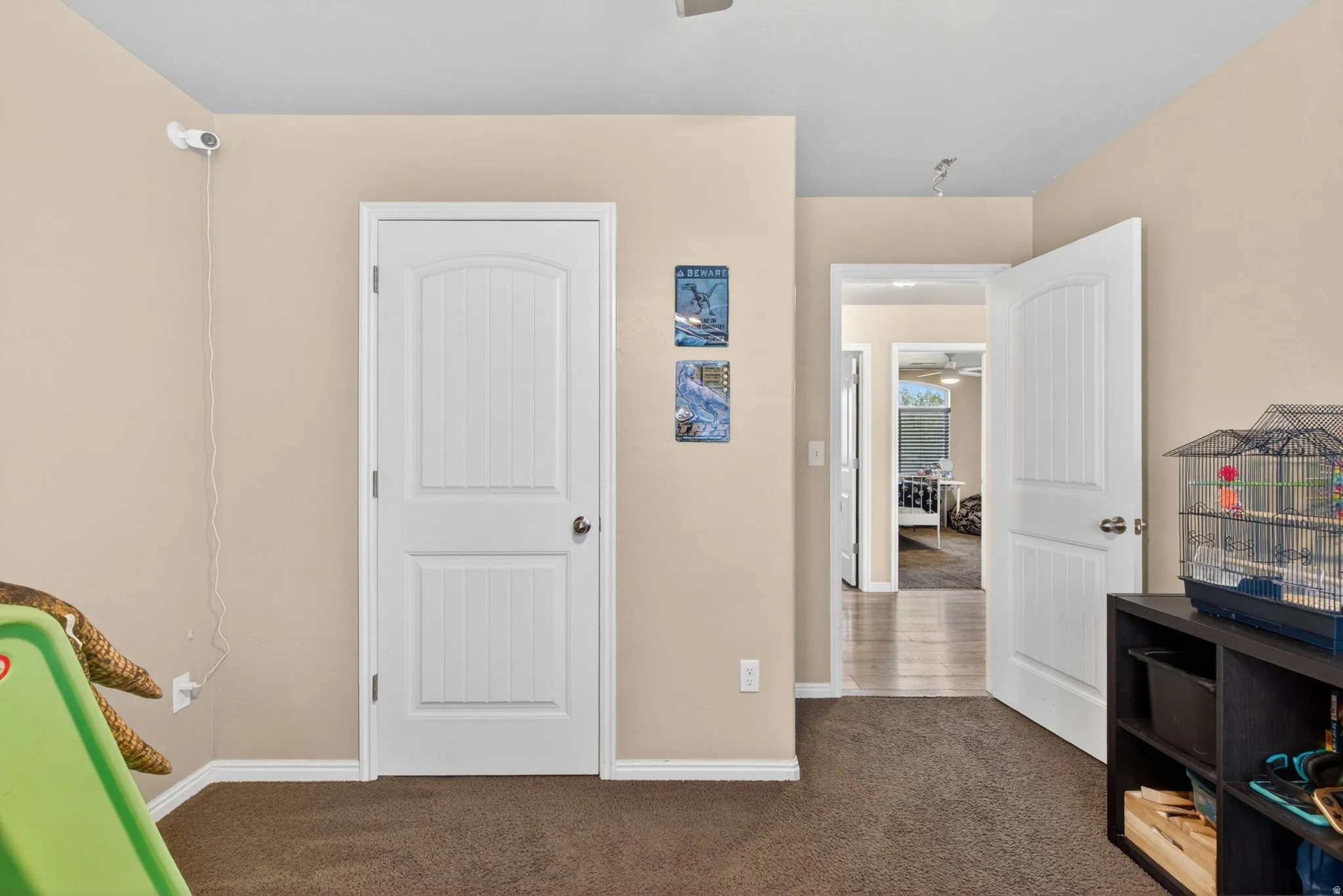 Rec room with ceiling fan and dark carpet