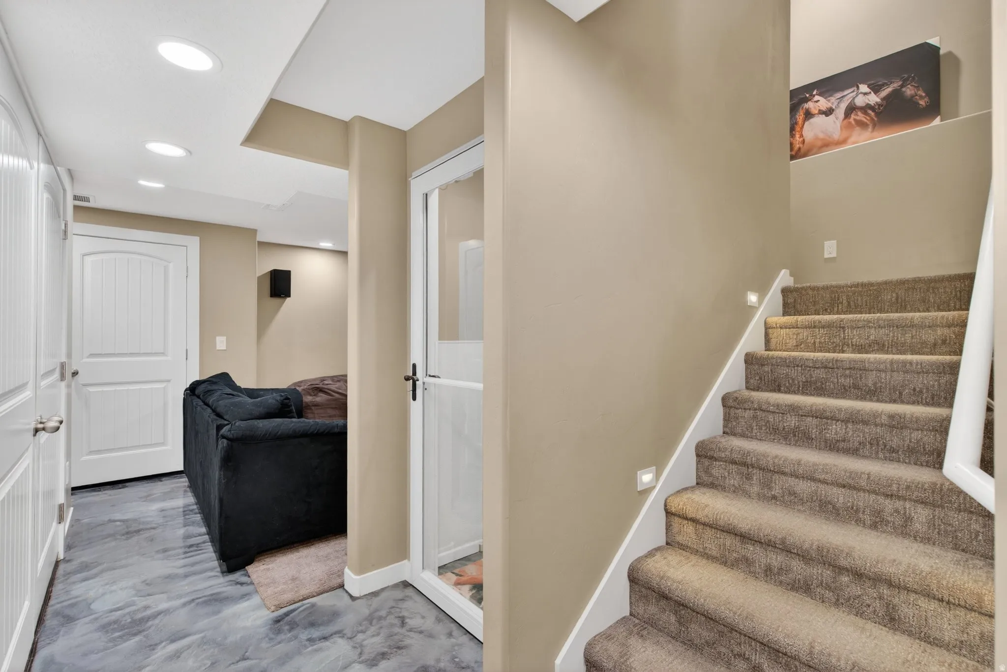 Staircase with recessed lighting and baseboards