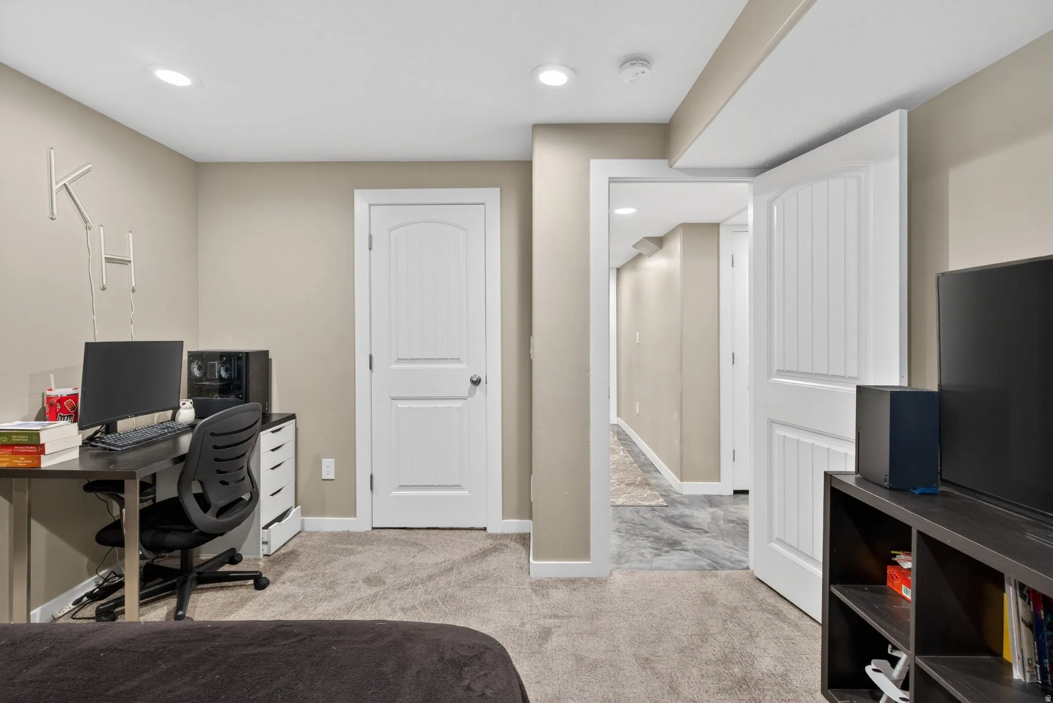 Bedroom with a desk, recessed lighting, and light colored carpet