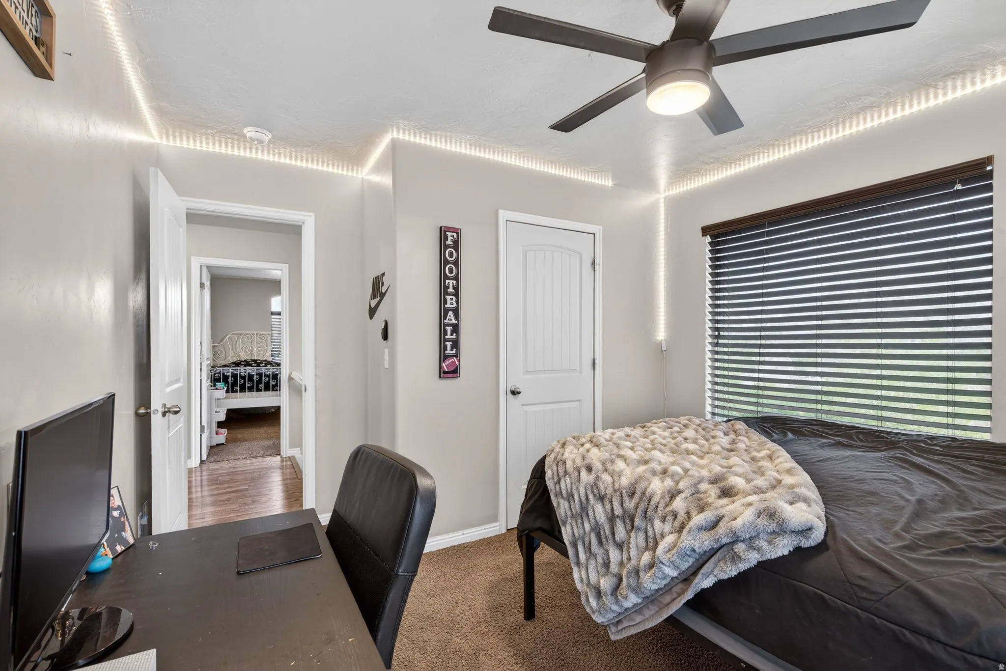 Bedroom featuring dark carpet and a ceiling fan