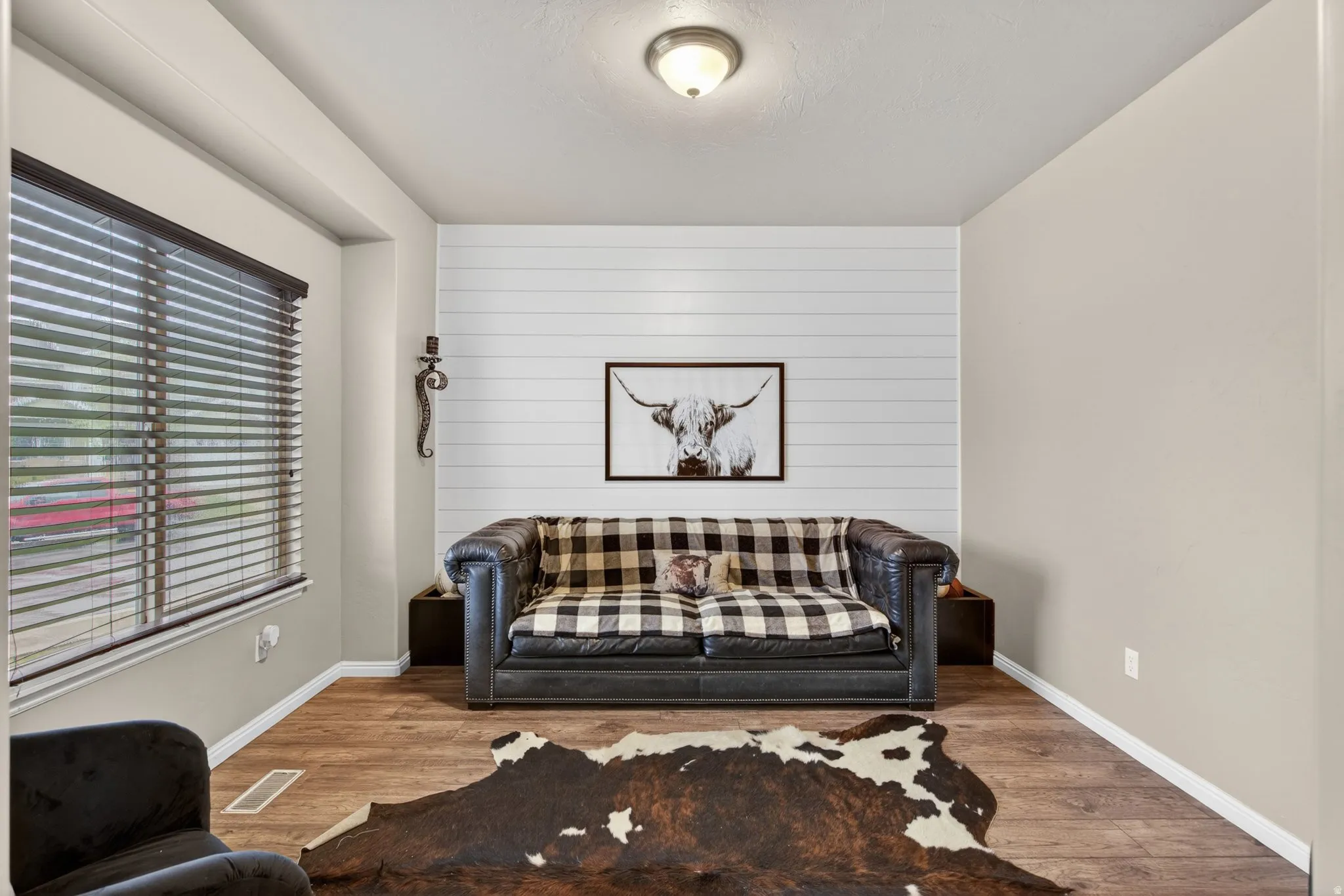 Living room with wood finished floors and wooden walls