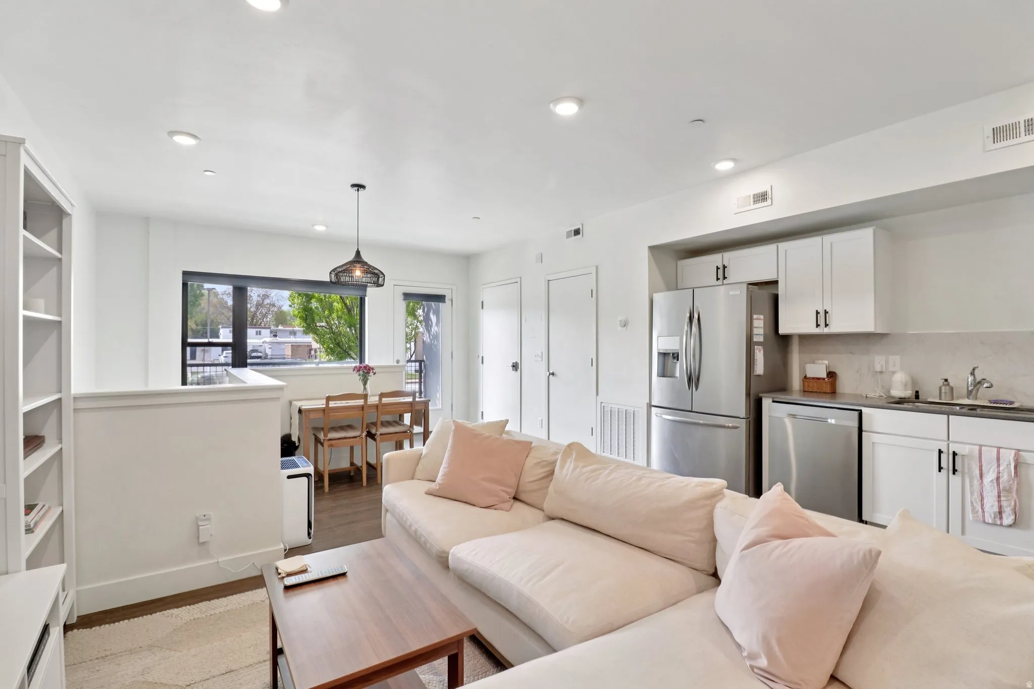 Living room with light wood-style floors and recessed lighting