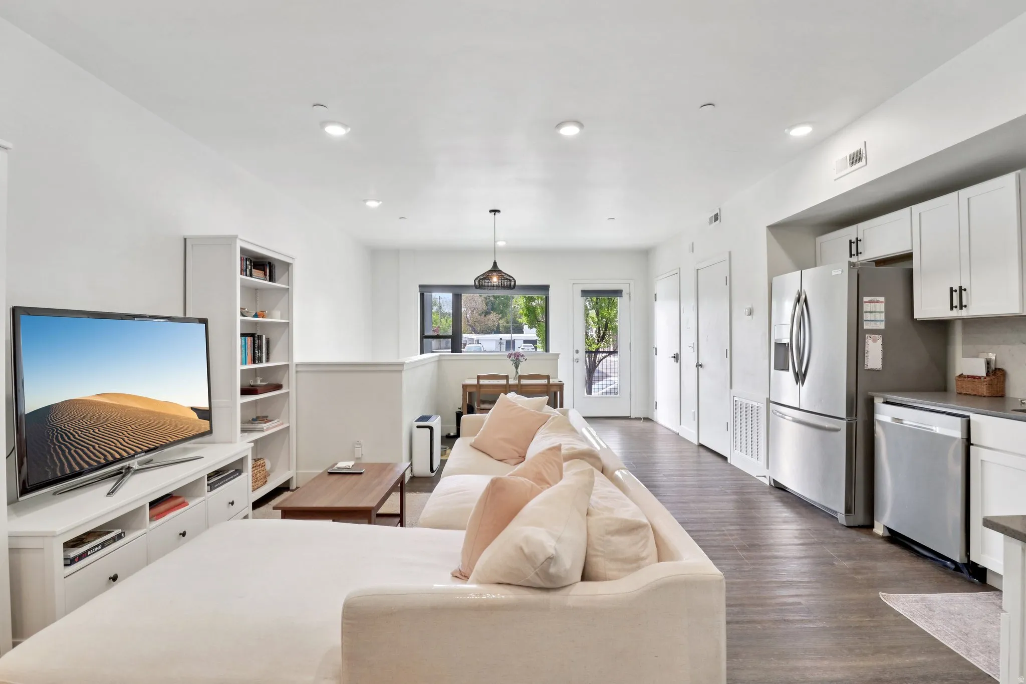 Living room with dark wood-style floors and recessed lighting