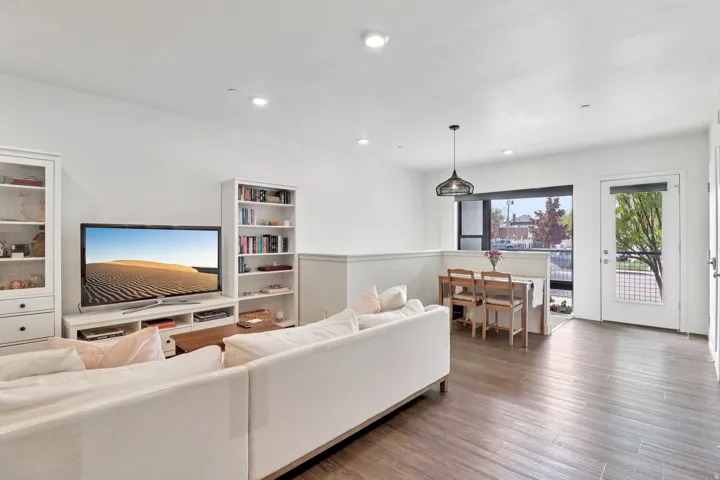 Living room featuring dark wood-type flooring and recessed lighting