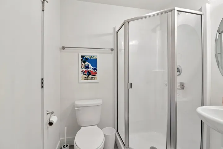 Full bath featuring toilet and a shower stall