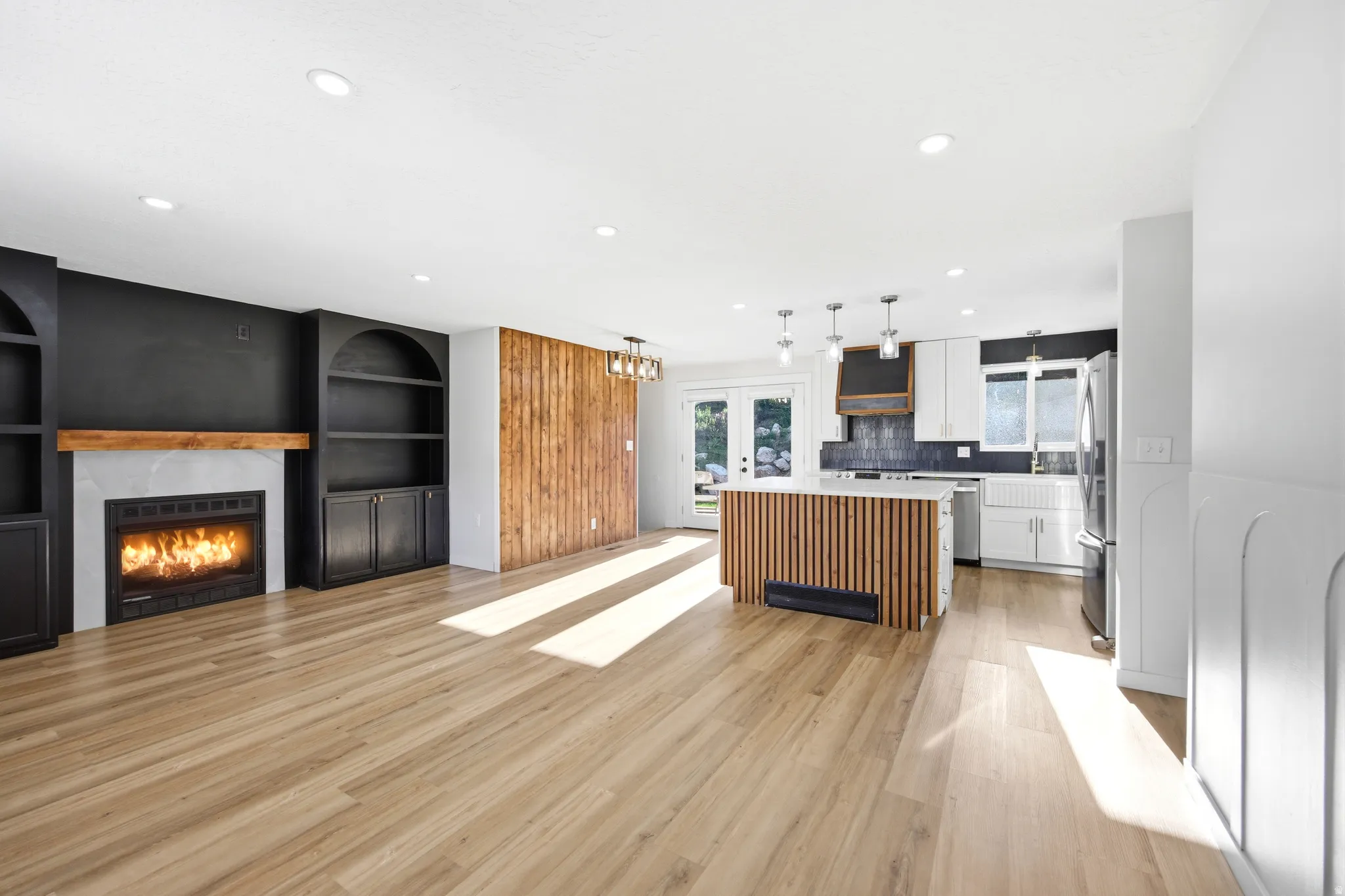 Open-concept living area with wood-finish flooring
