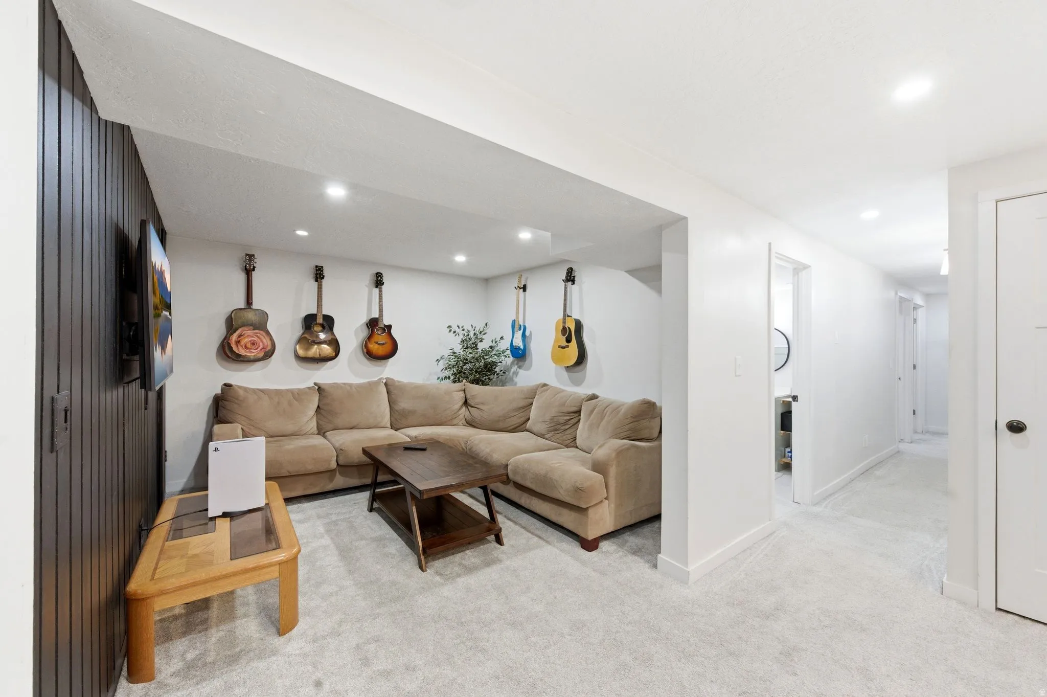 Living area featuring light carpet and recessed lighting