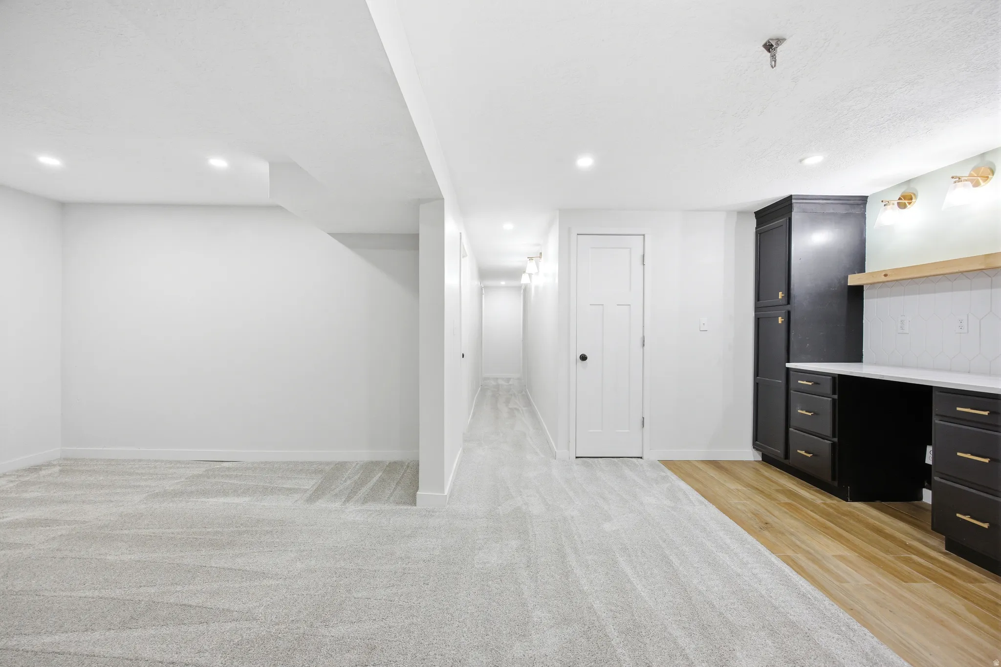 Spacious finished room featuring light gray carpeting and recessed lighting