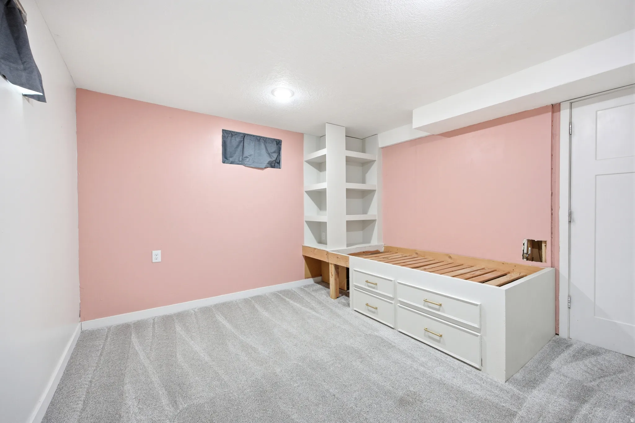 Built-in shelving and platform bed frame with storage drawers