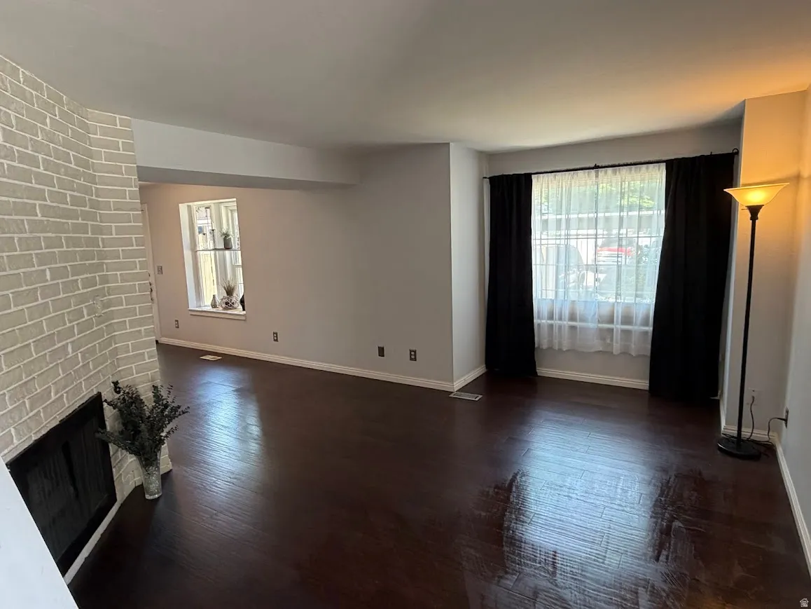 Living space featuring rich wood-finish flooring and light gray painted walls