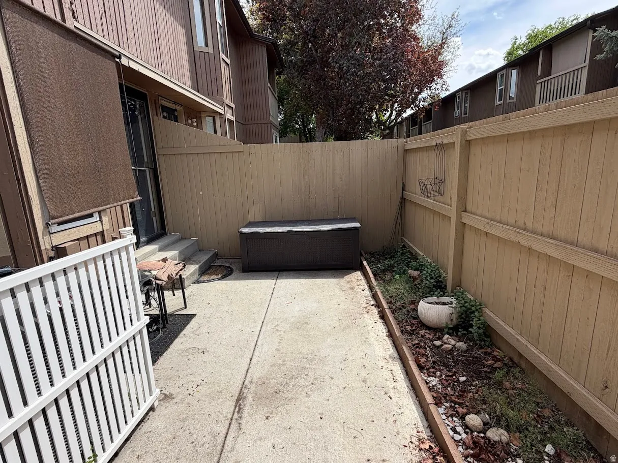 Fenced backyard with a patio and entry steps