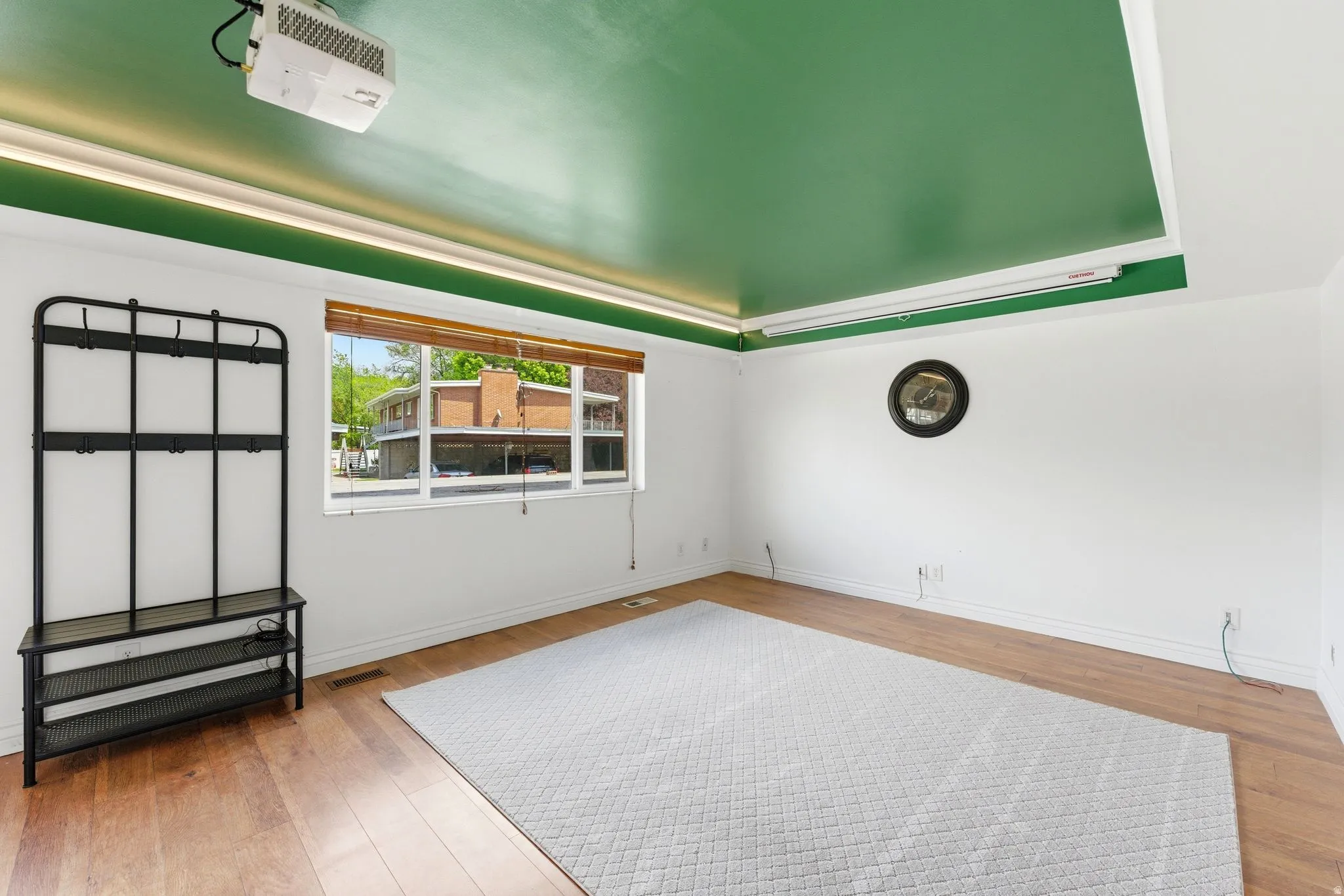 Unfurnished room with a raised ceiling and hardwood / wood-style flooring