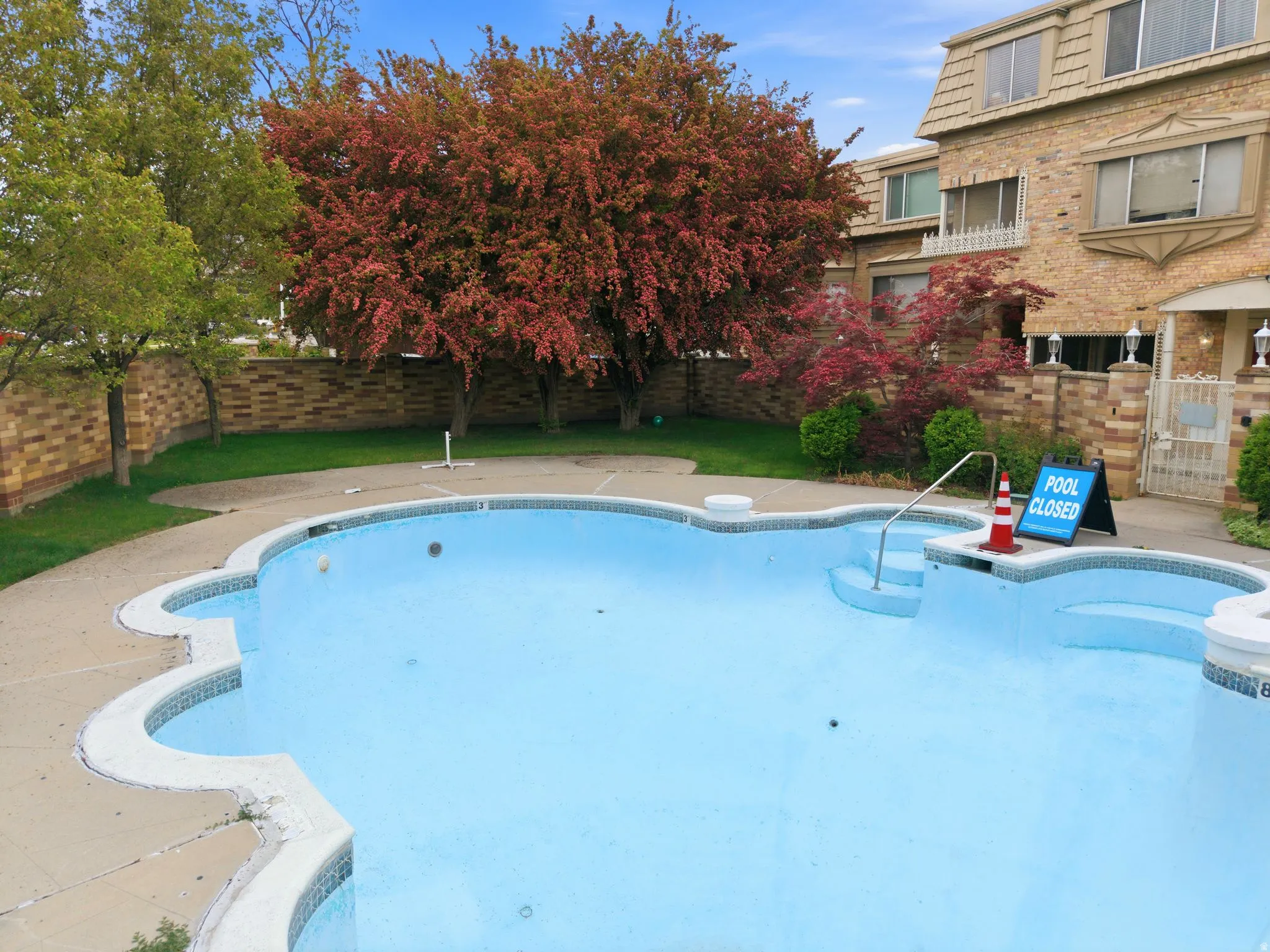 View of swimming pool featuring a fenced backyard and patio surround